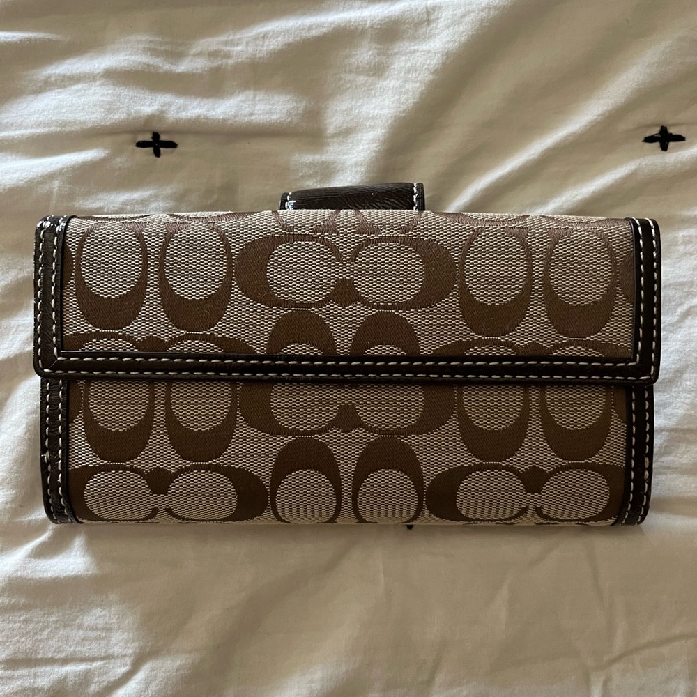 Brown coach wallet and check cover